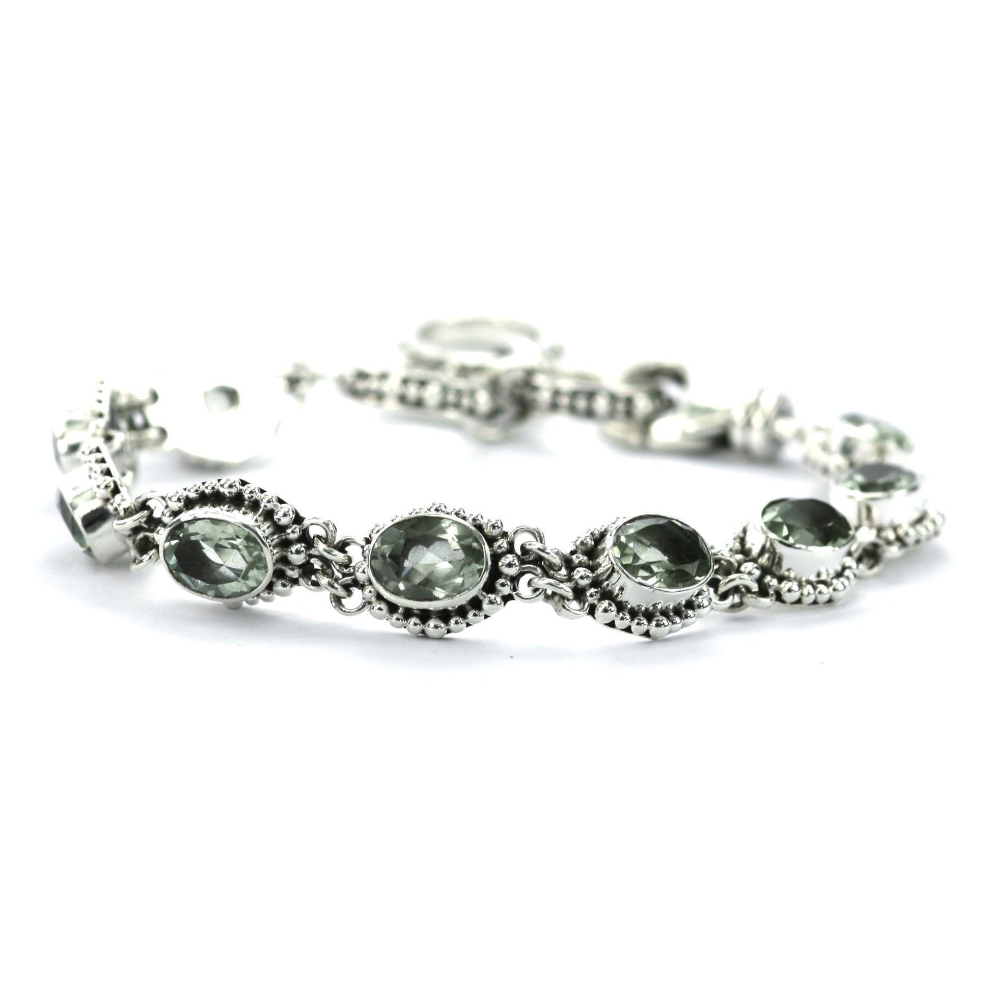 Silver link bracelet with nine green amethyst gemstones and beaded accents.