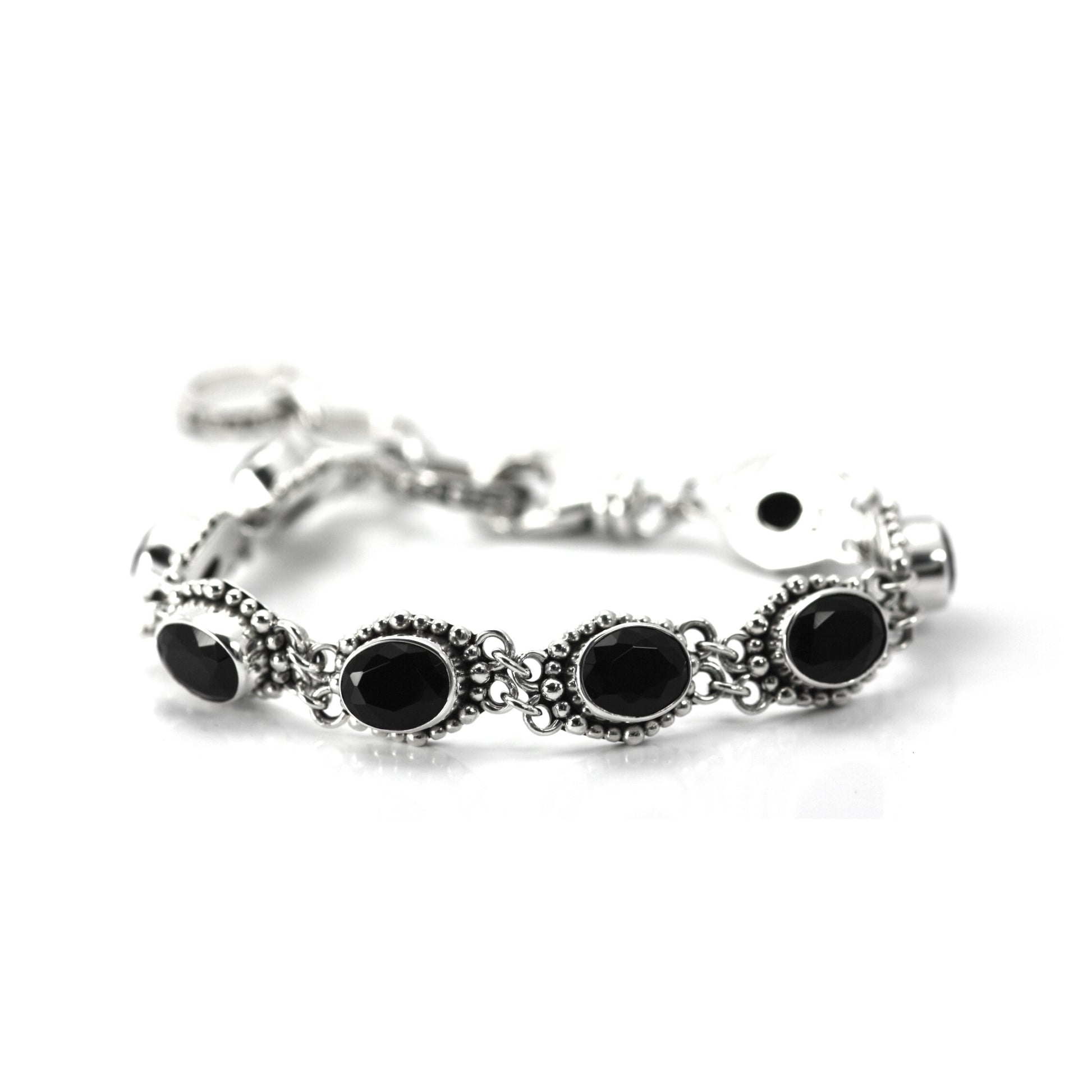 Silver bracelet with nine oval onyx gemstones set in beaded links.