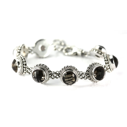 Silver link bracelet with eight round faceted smoky topaz gemstones and beaded borders on each link