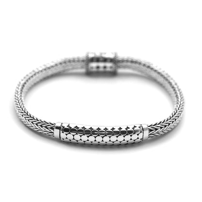 Silver snake chain bracelet with a station in the middle with flat silver dots.