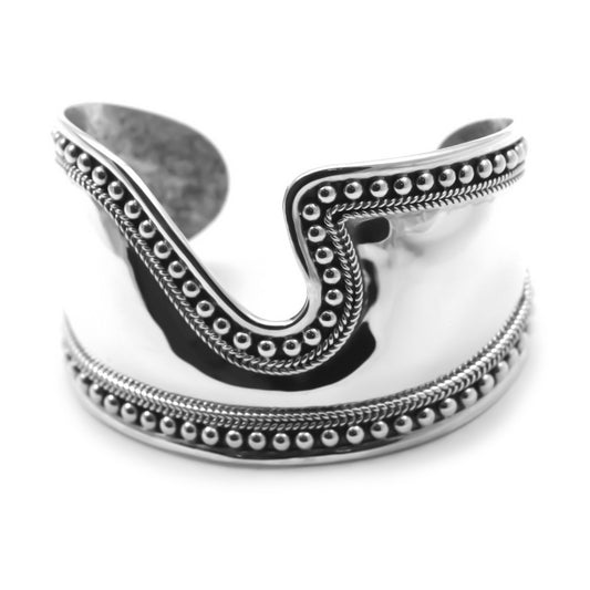 Bold silver cuff bracelet with mirror finish in the center and beaded edges.
