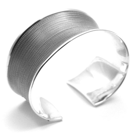 Bold, wide silver cuff bracelet with strands of silver wire running across it. 