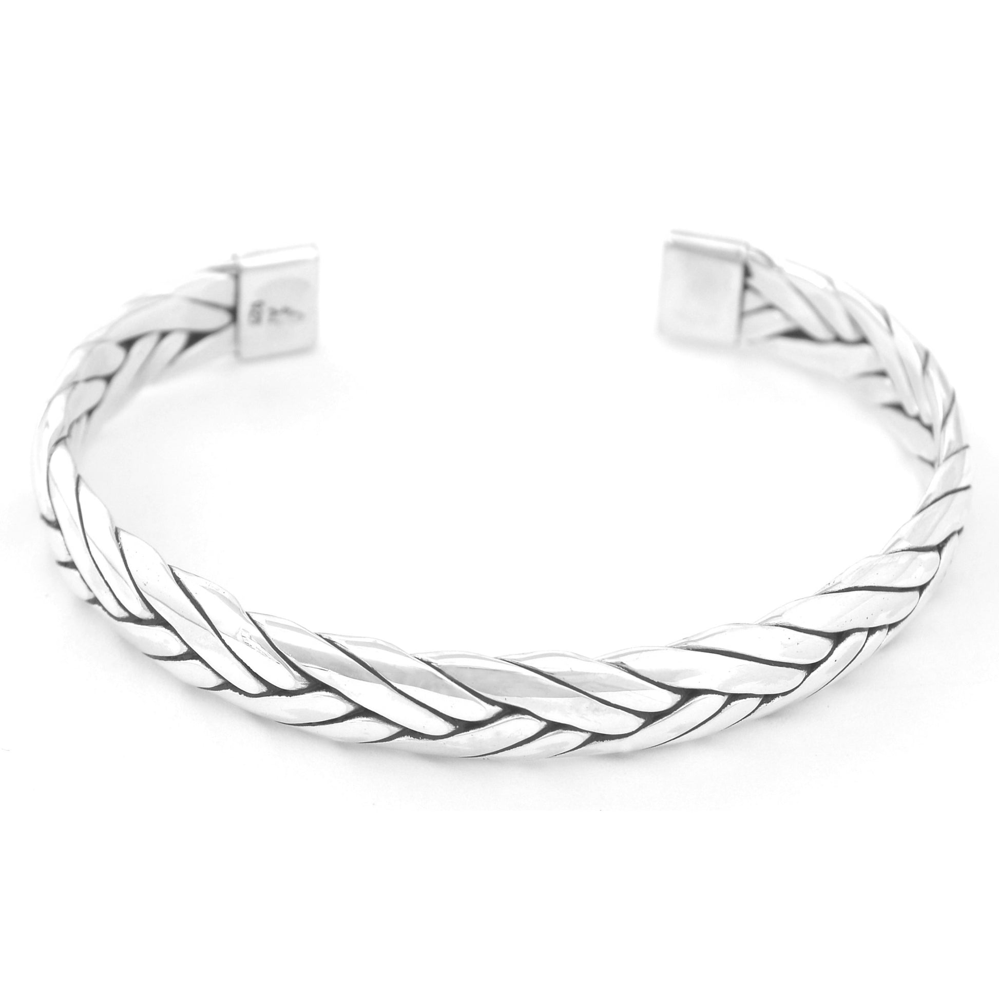 Wide silver cuff bracelet made of braided flat sterling strips.