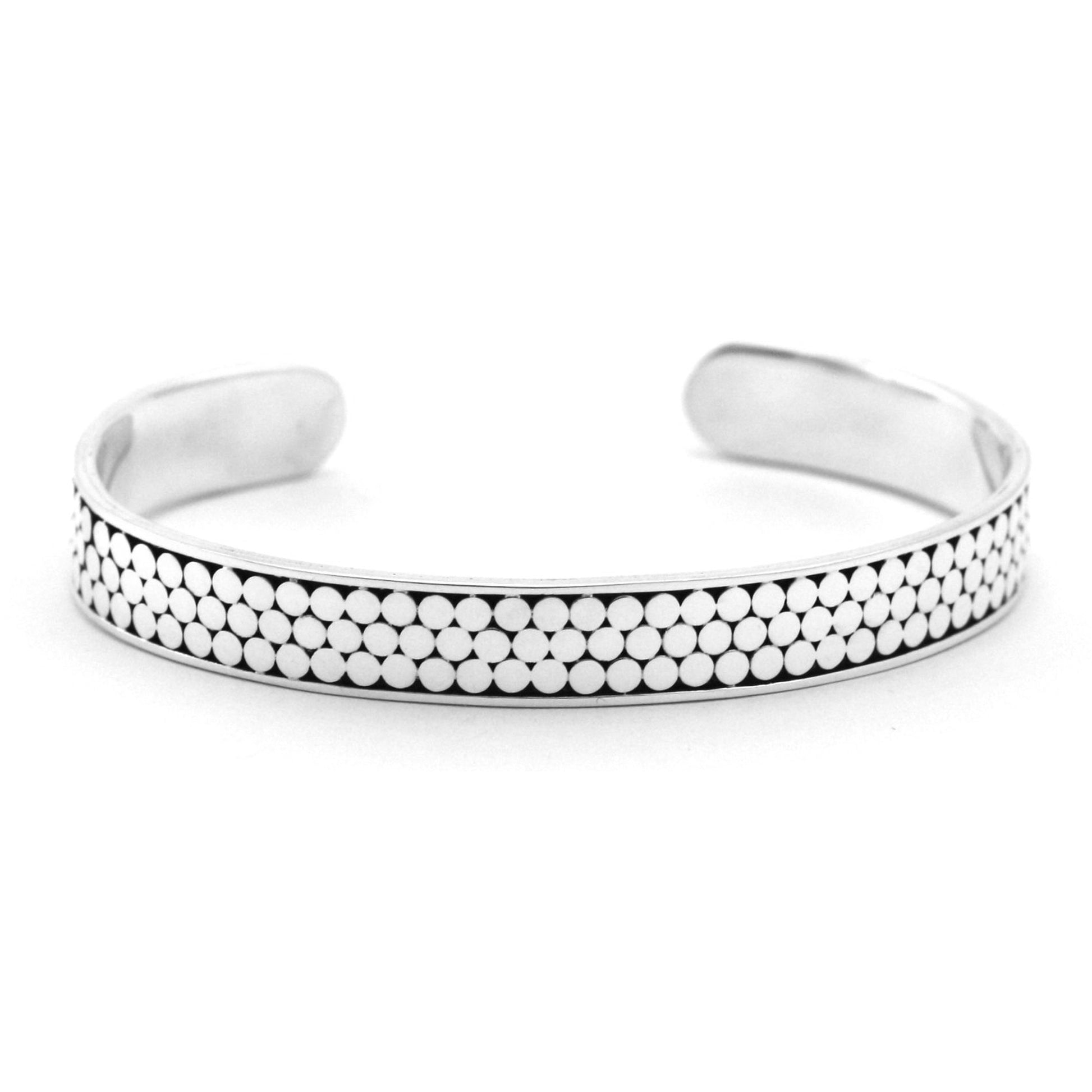 Silver cuff bracelet with three rows of flat dots.