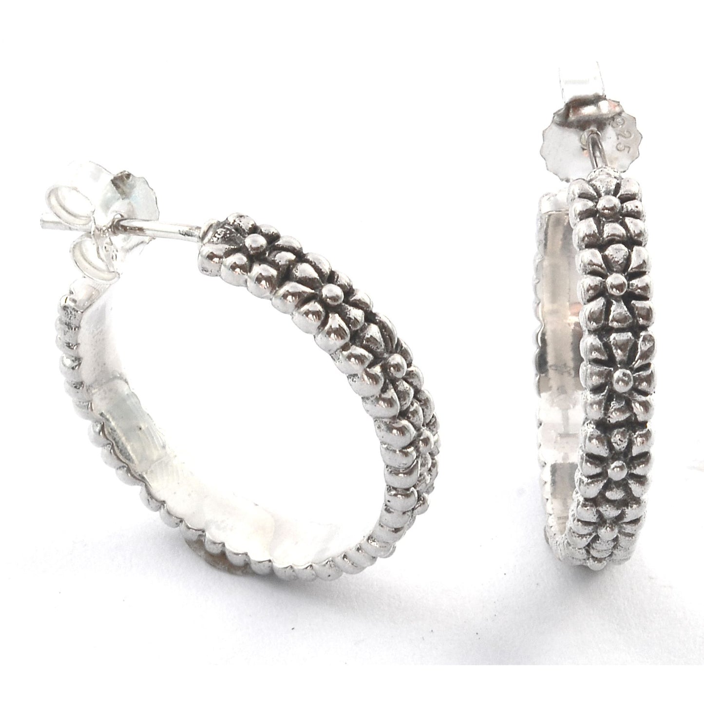 Sterling silver textured hoop earrings.