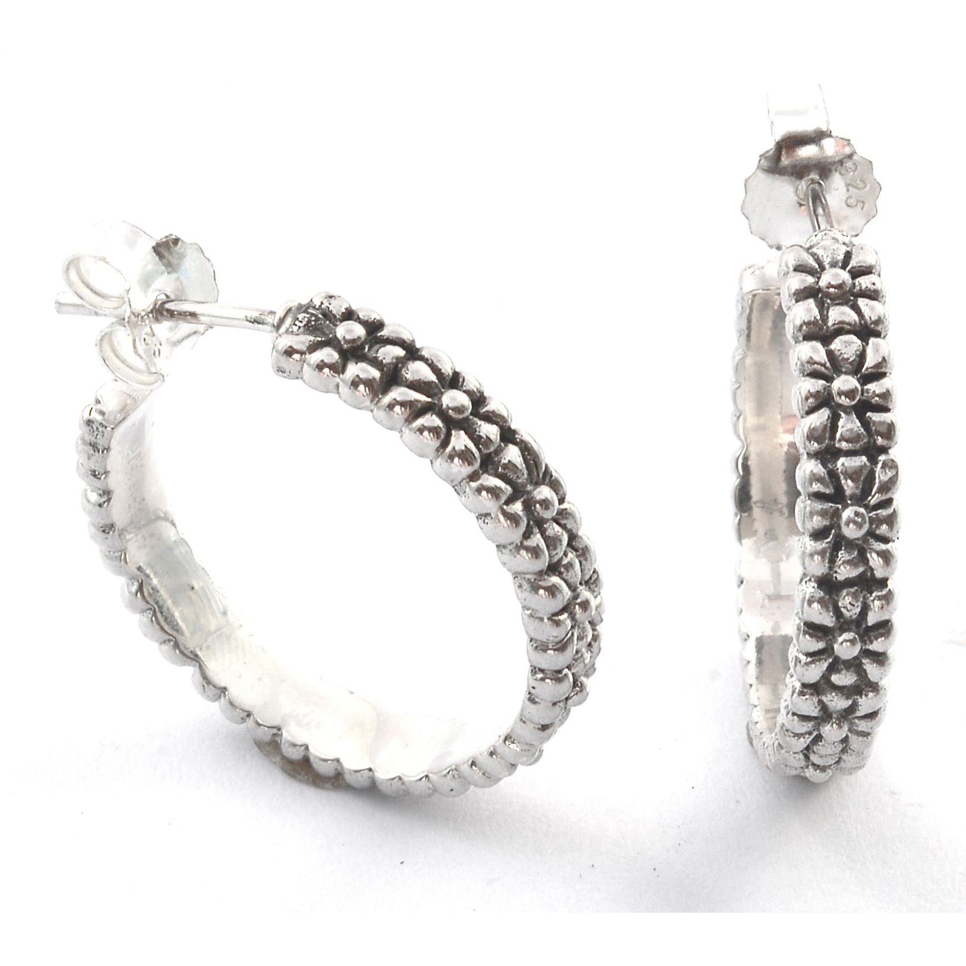 Sterling silver textured hoop earrings.