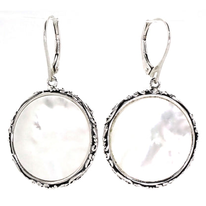 Silver filigree and bead earrings with mother of pearl discs.