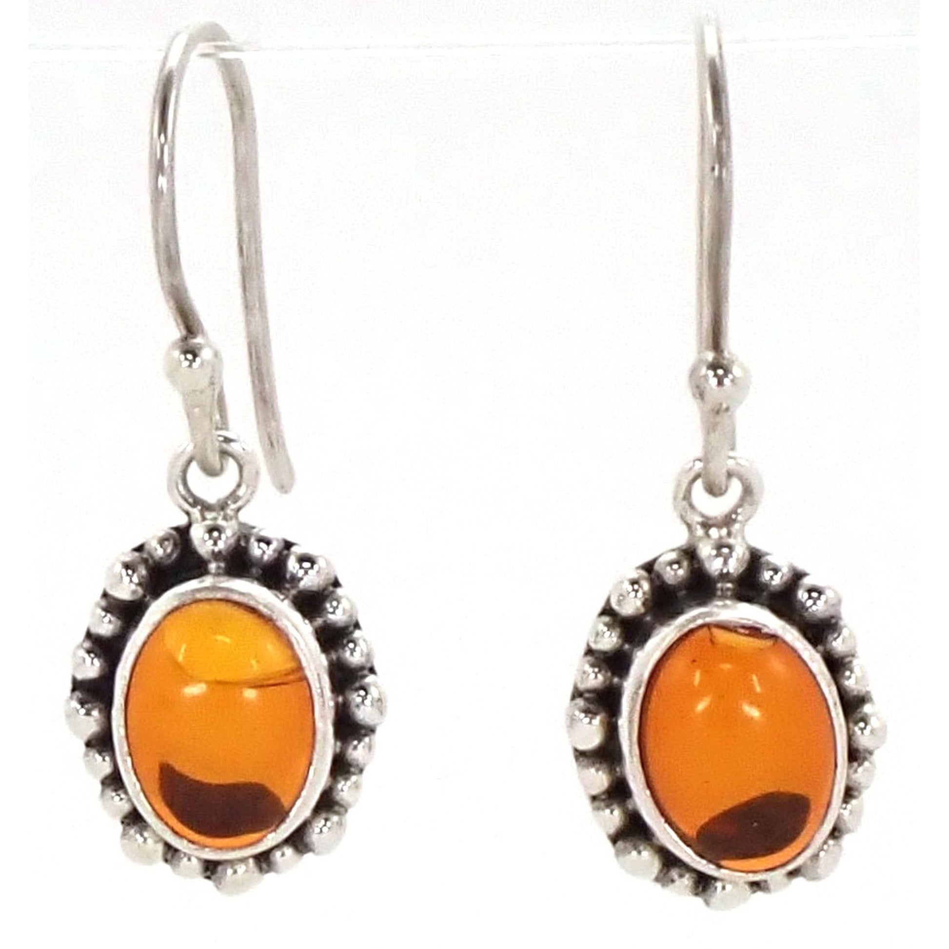 Silver earrings with oval amber gemstones.
