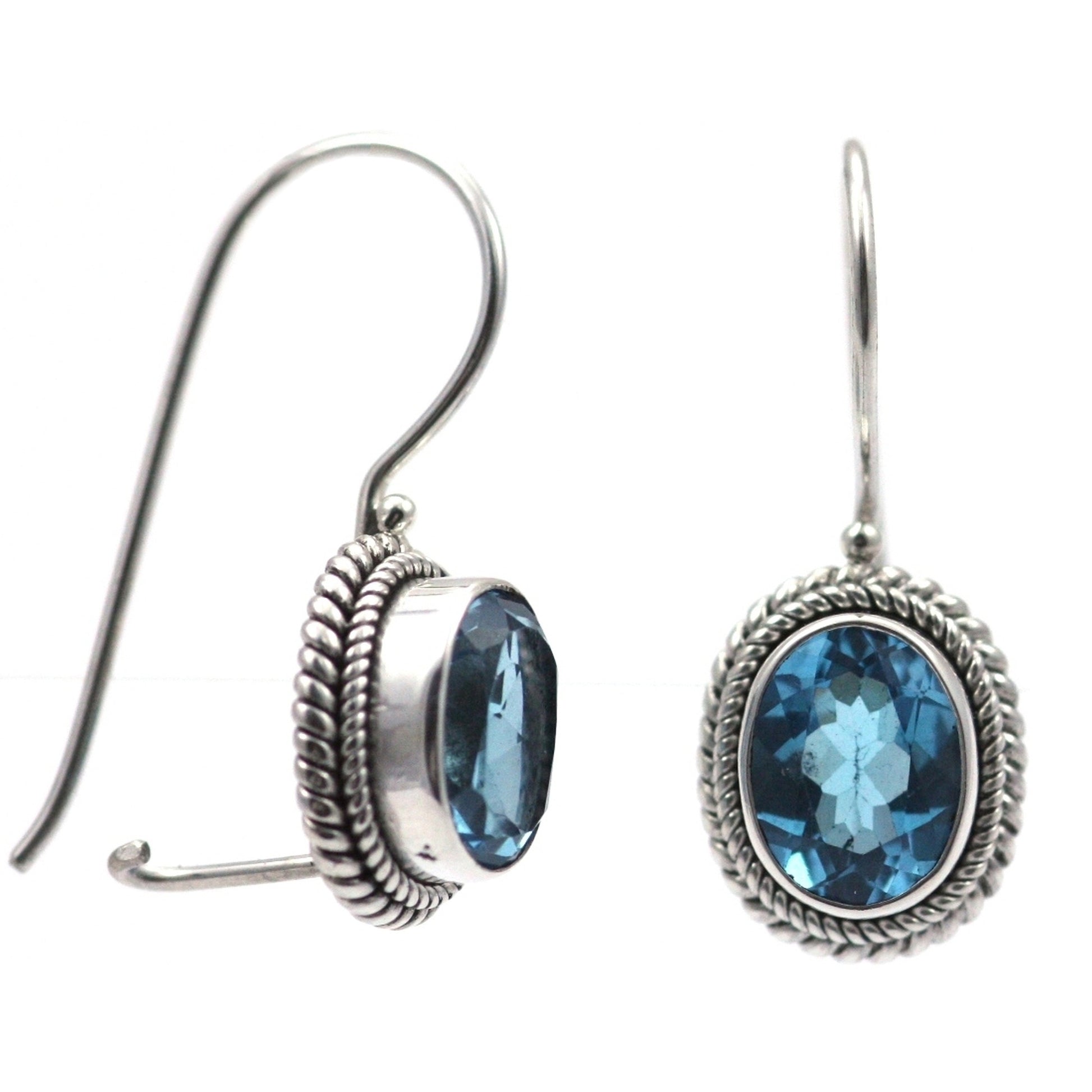 Silver earrings with rope trim and oval blue topaz gemstones.