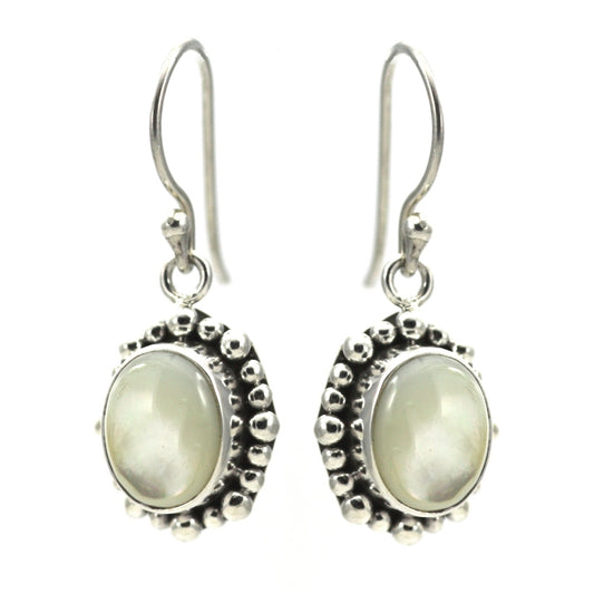 Silver earrings with oval mother of pearl stones and beaded borders.