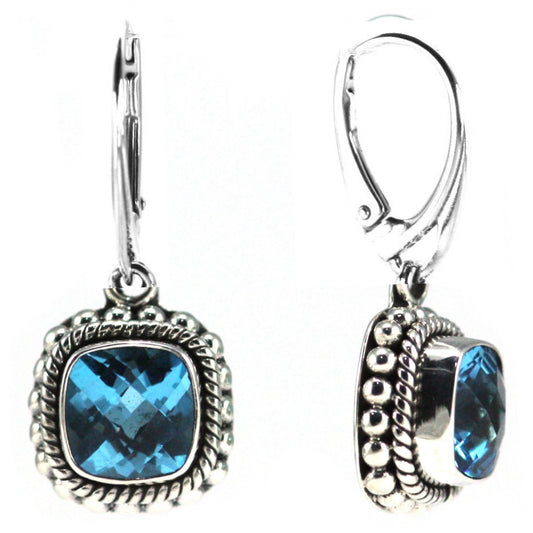 Silver earrings with faceted blue topaz gemstones.