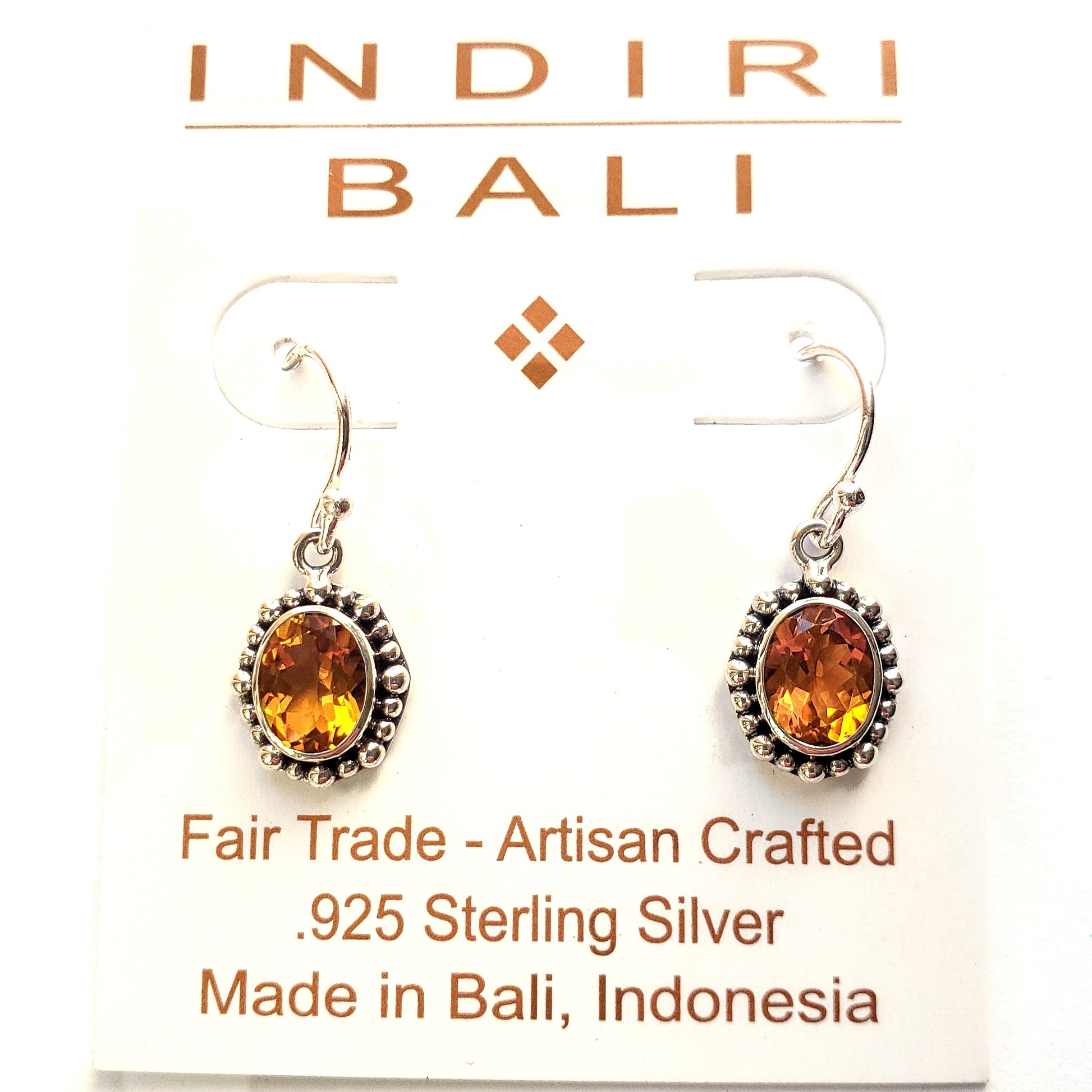 Silver earrings with oval citrine gemstones.