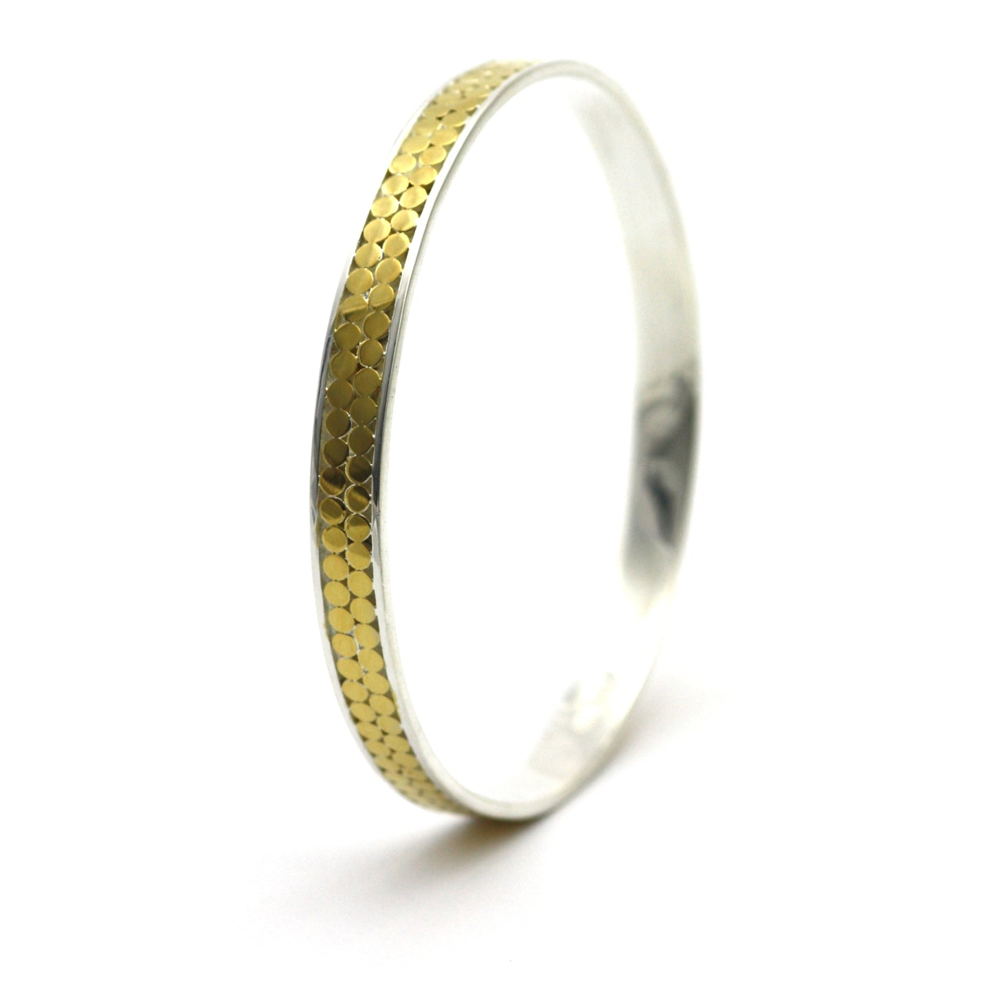 Silver and gold bangle bracelet with two rows of flat dots.
