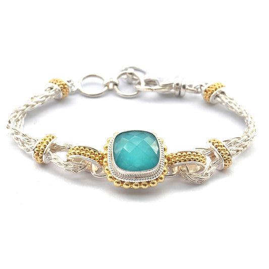 Silver and 18 karat gold vermeil bracelet with a beaded center station holding a turquoise doublet gemstone.