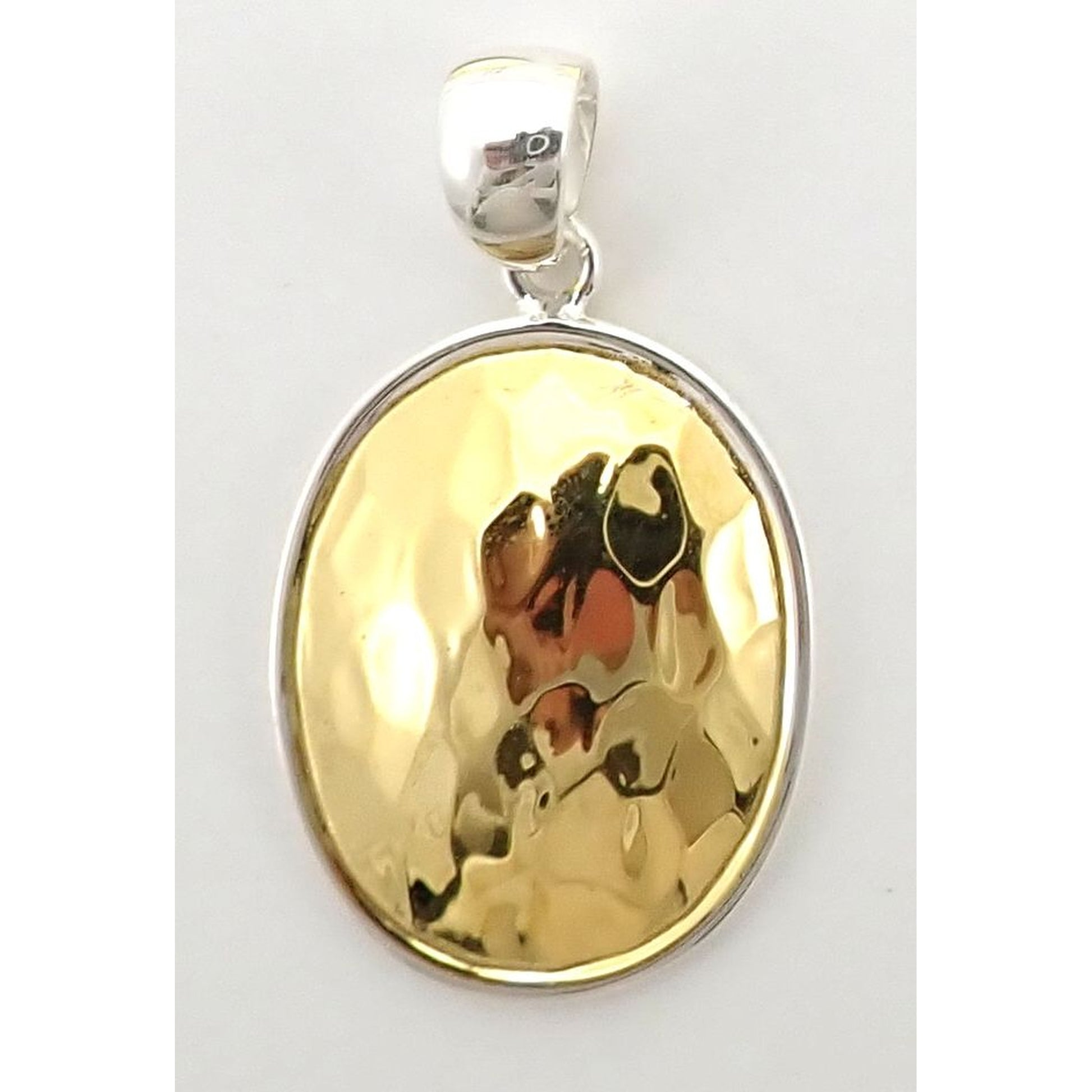Sterling silver and gold oval pendant.