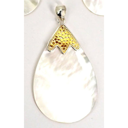 Sterling silver and gold pendant with mother of pearl.