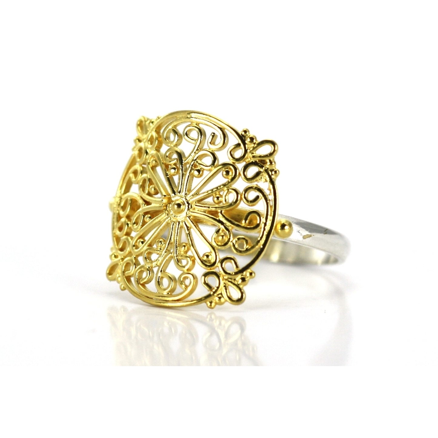 Silver and gold ring with wire filigree design.