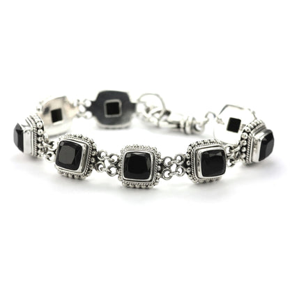 Silver link bracelet with eight square onyx gemstones, beaded borders on each link, and a lobster claw clasp