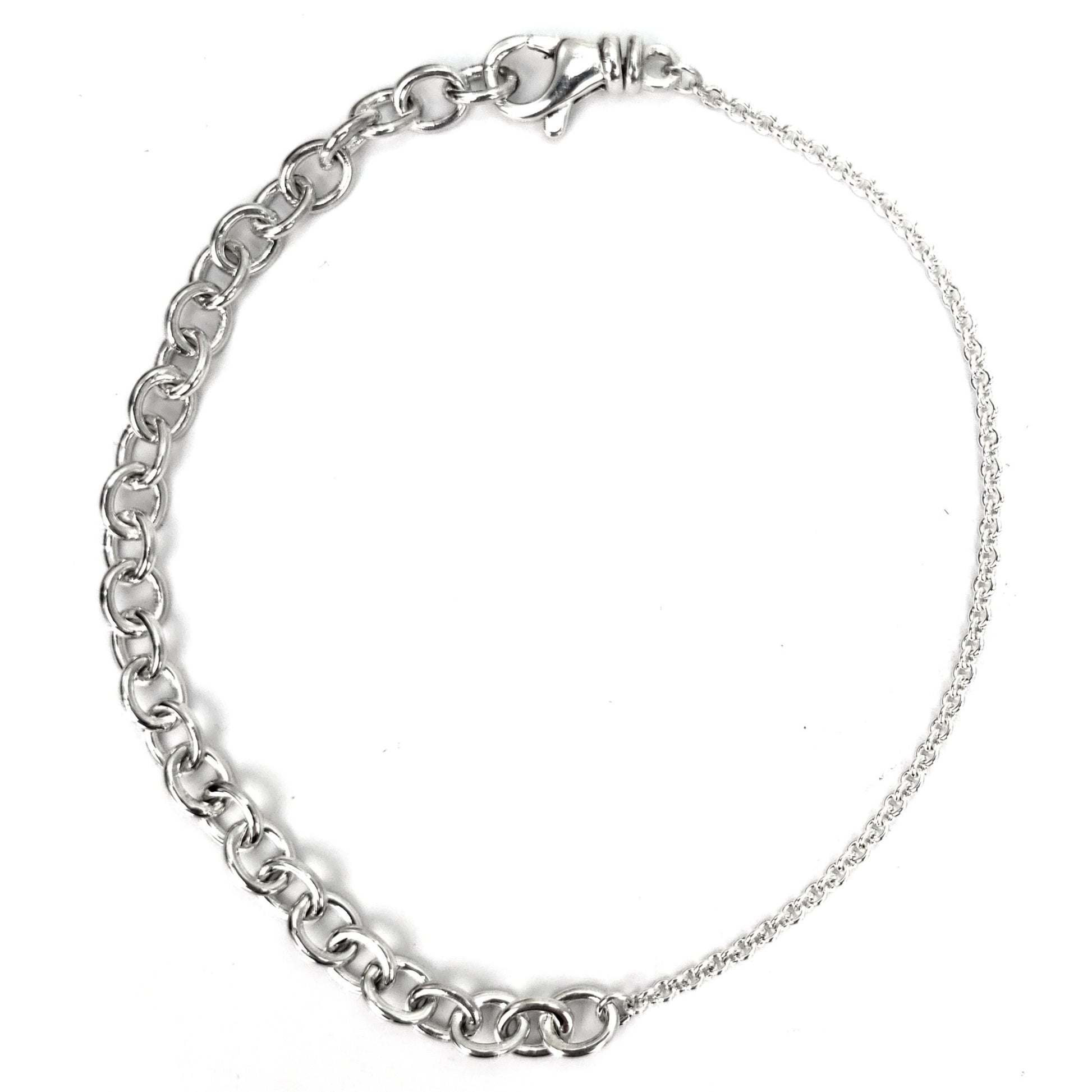 Silver bracelet made of two different chain styles in line.