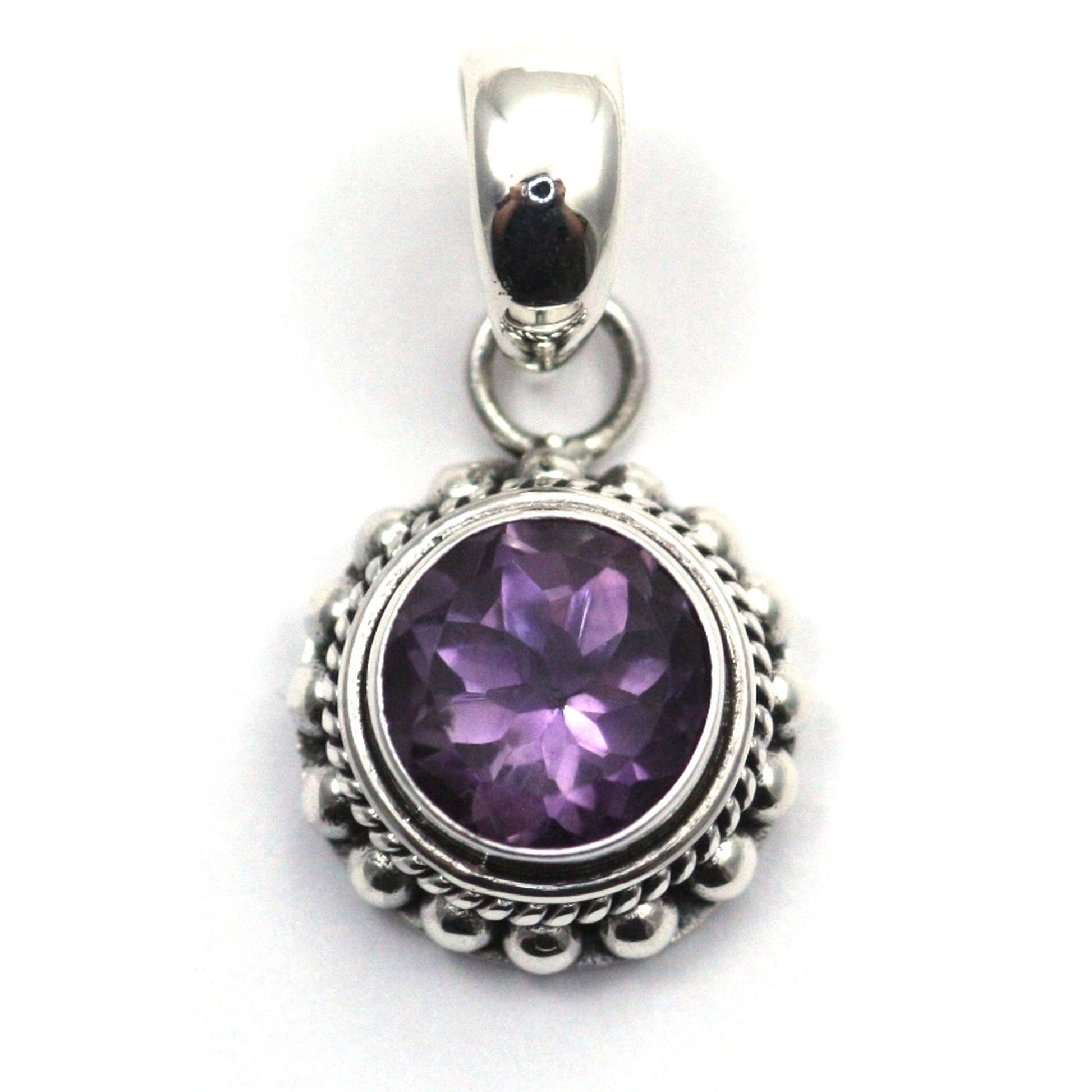 Sterling silver and round amethyst pendant. 