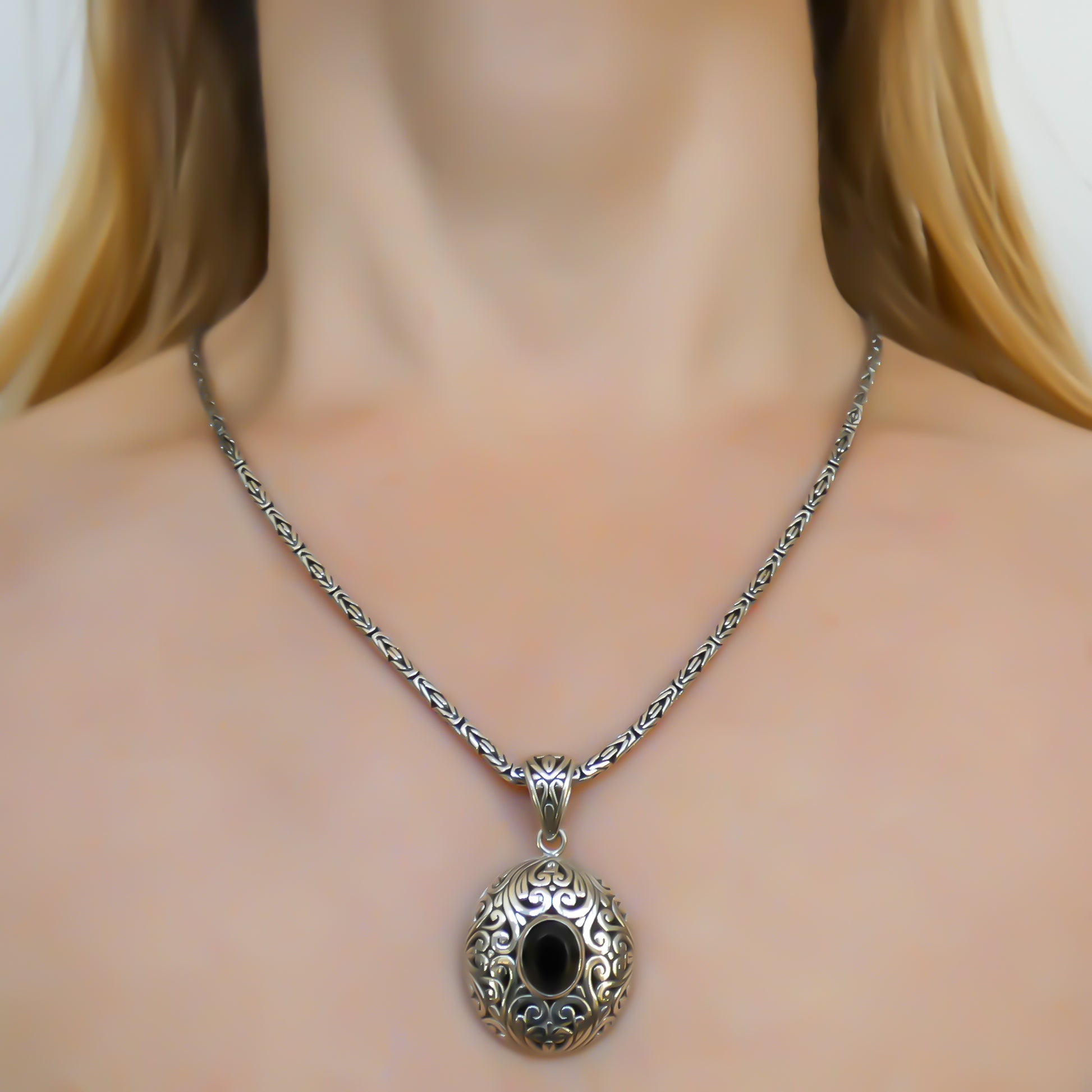 Sterling silver and faceted onyx pendant.