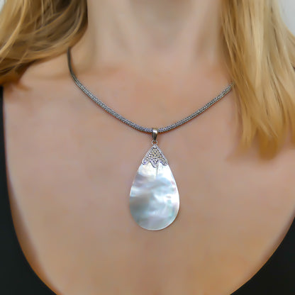 Sterling silver and mother of pearl teardrop shaped pendant.