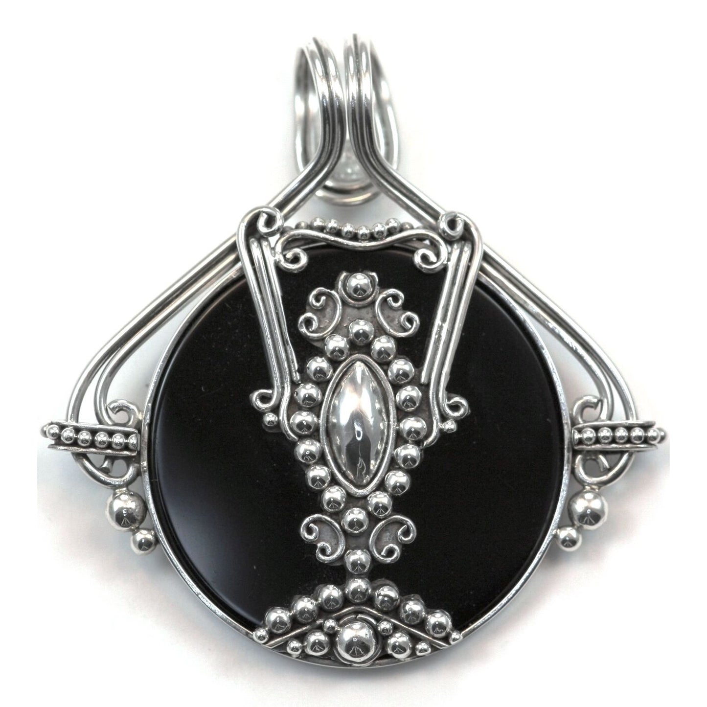 Sterling silver and black onyx disc pendant.