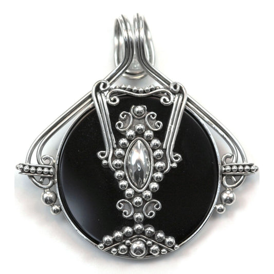Sterling silver and black onyx disc pendant.