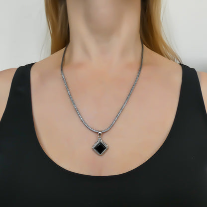 Sterling silver and faceted black onyx pendant.