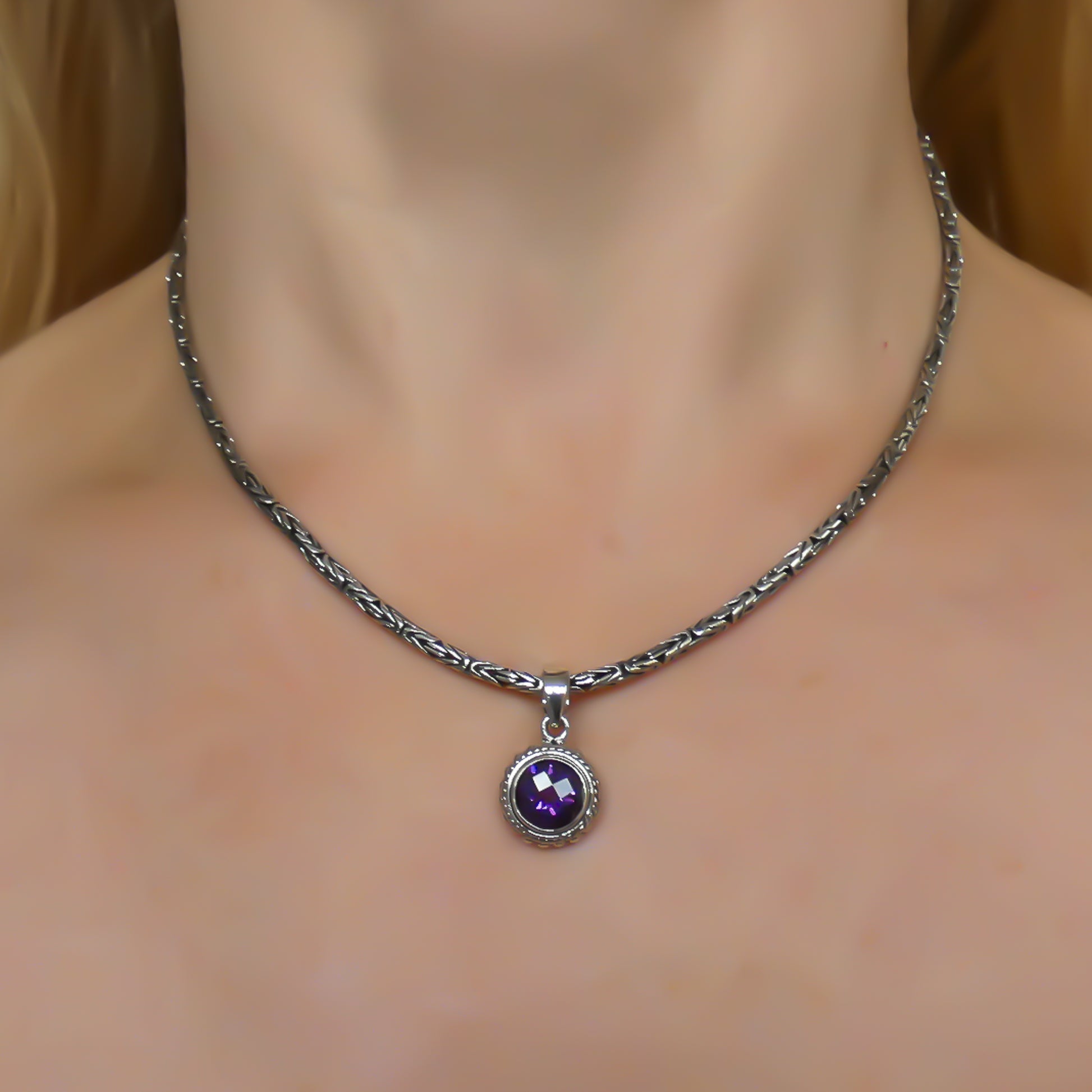 Sterling silver and round amethyst pendant. 