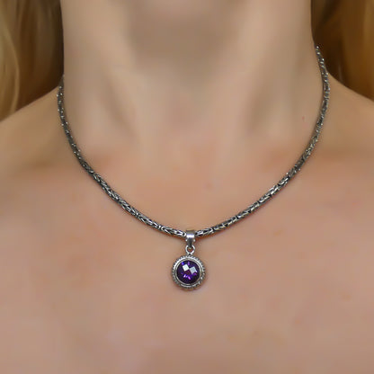 Sterling silver and round amethyst pendant. 
