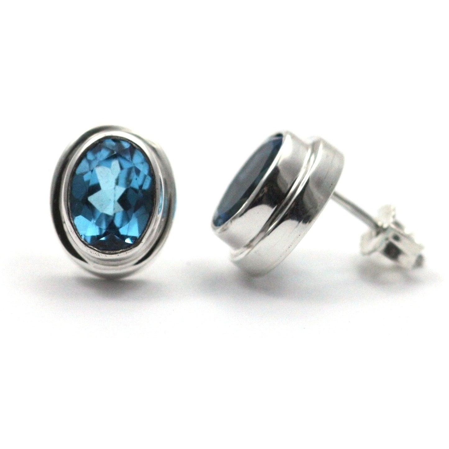 High polish plain setting sterling silver oval post earrings with blue topaz.