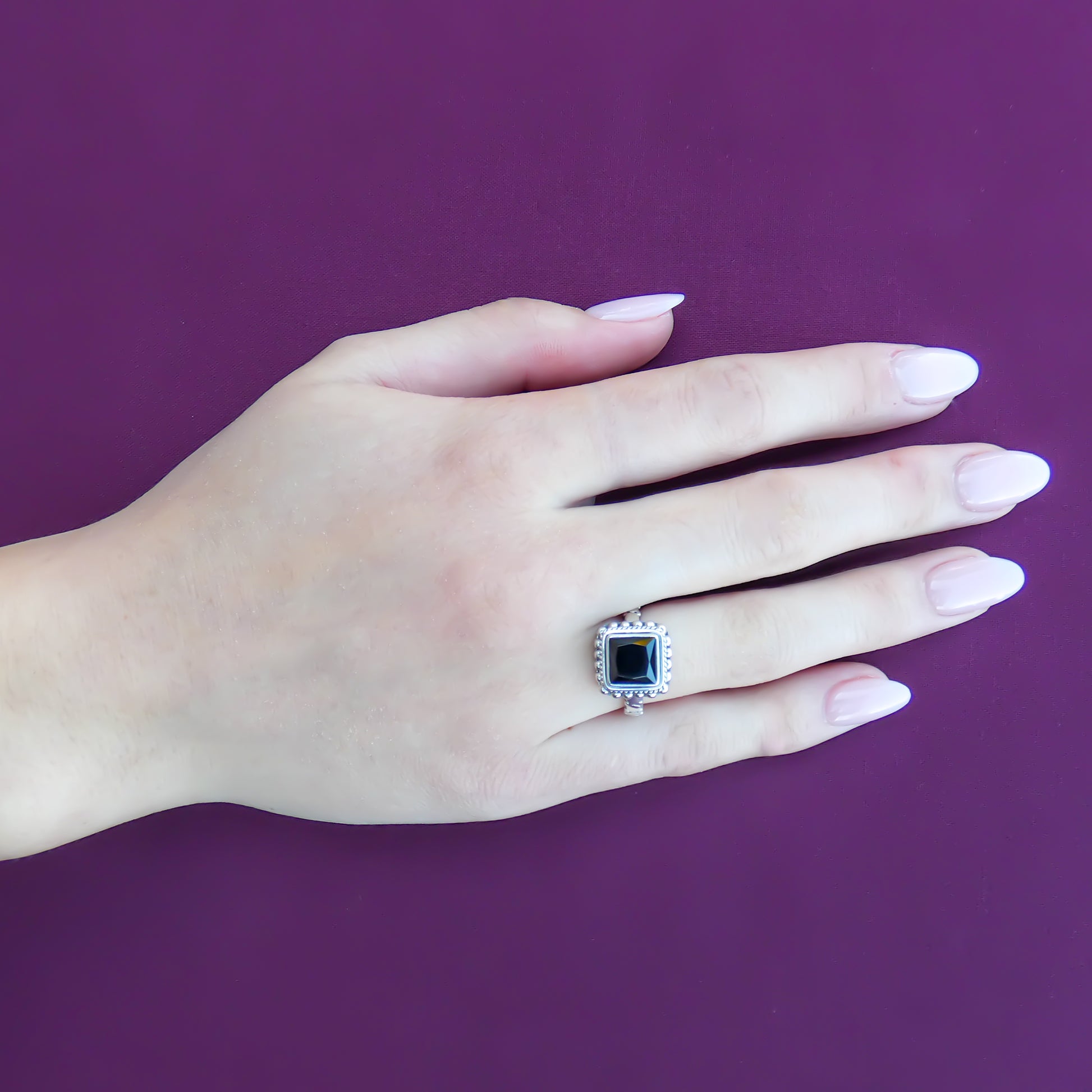 Sterling silver and faceted black onyx ring.