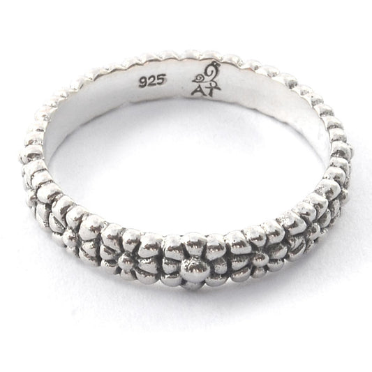 Silver ring with floral design motif.