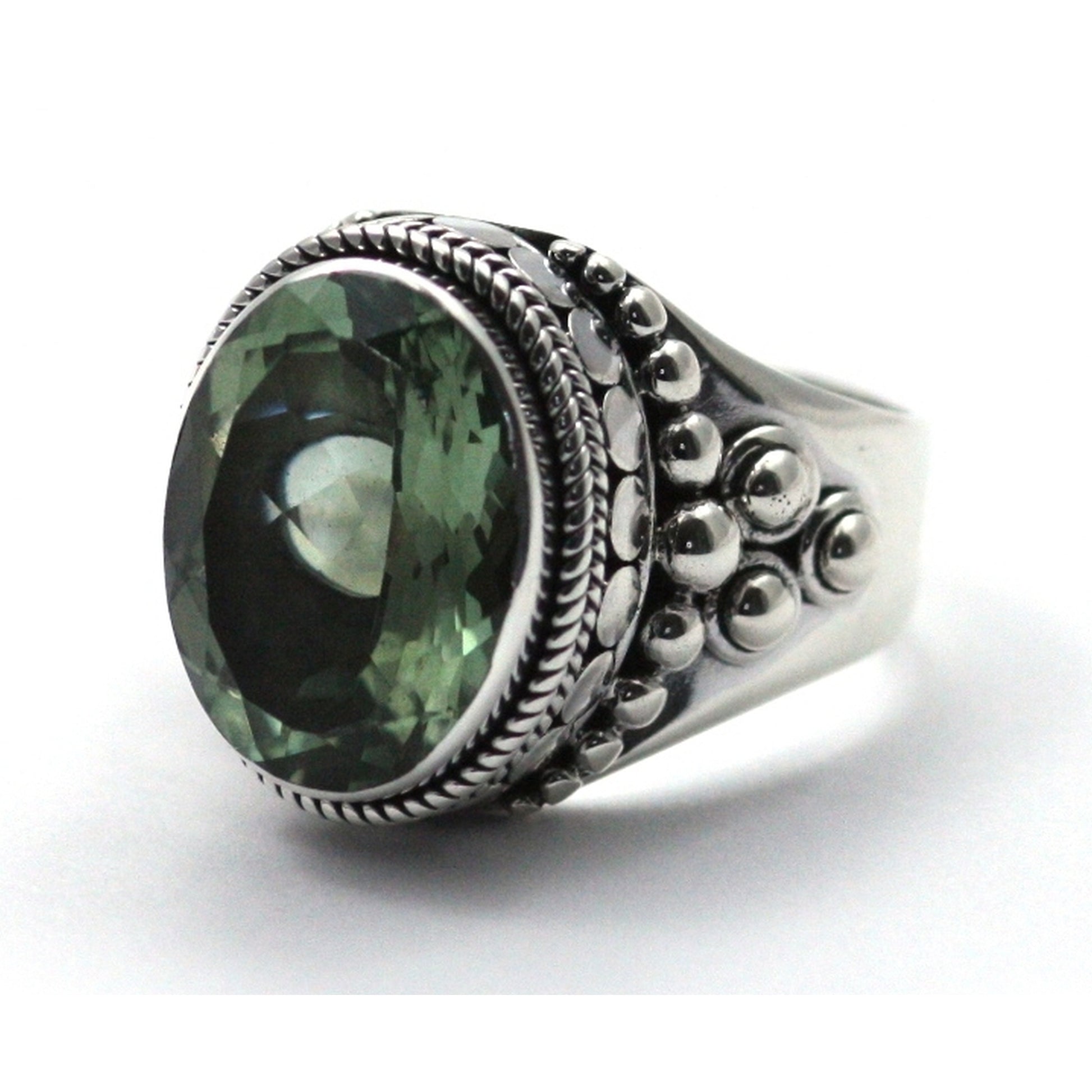 Silver ring with oval green amethyst gemstone.
