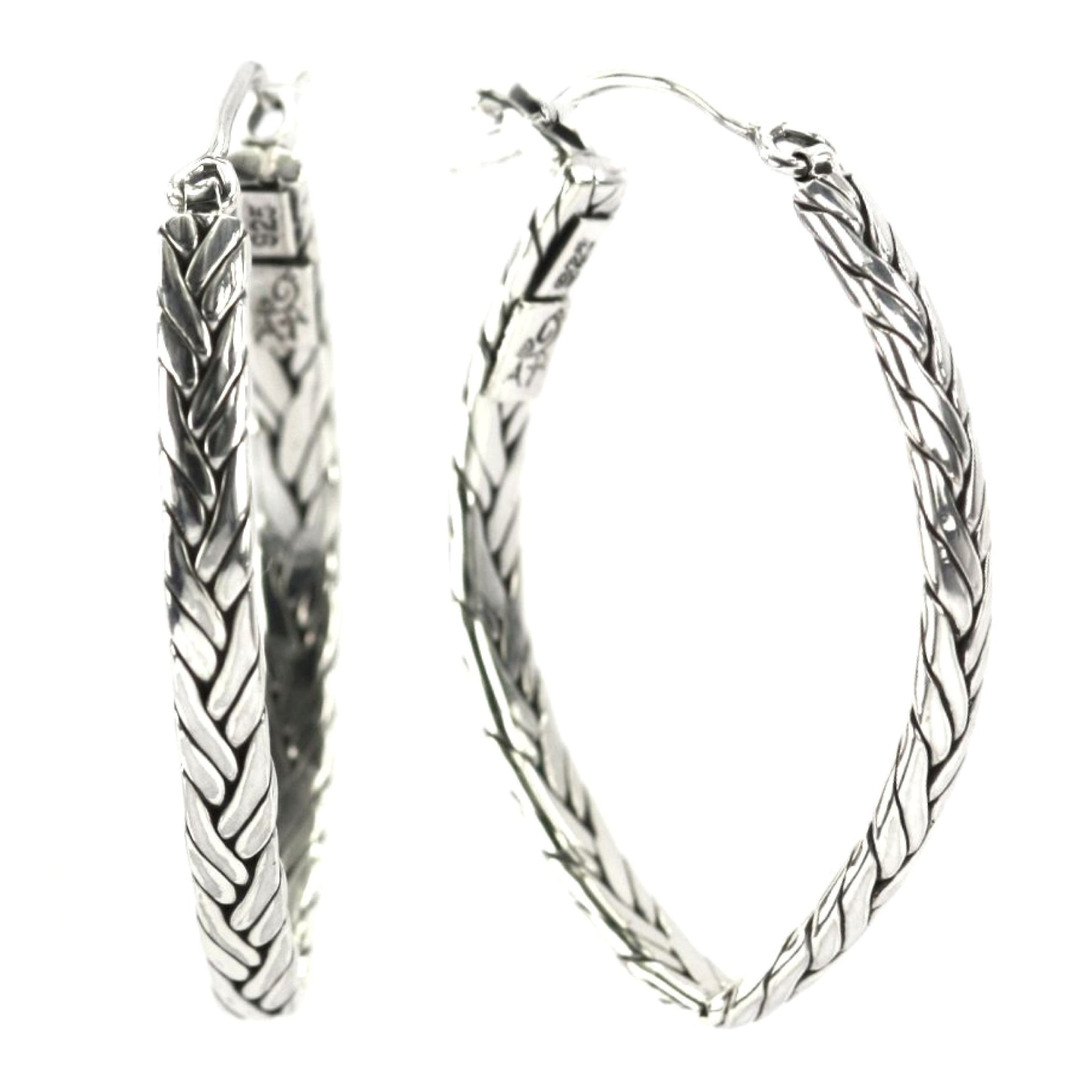 Silver earrings with V shape and woven strands.