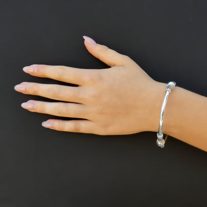 Woman wearing a classic Bali bangle bracelet with beaded and rope design stations.