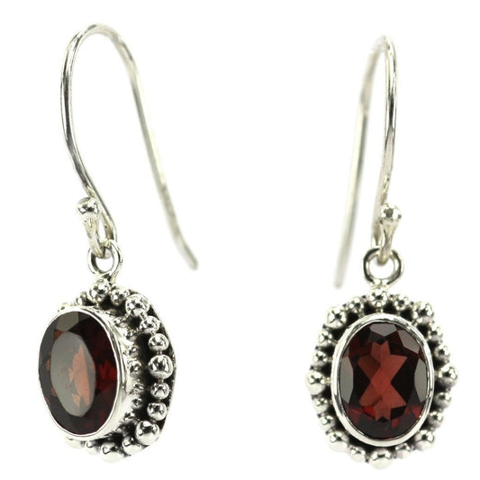Silver earrings with faceted garnet gemstones.