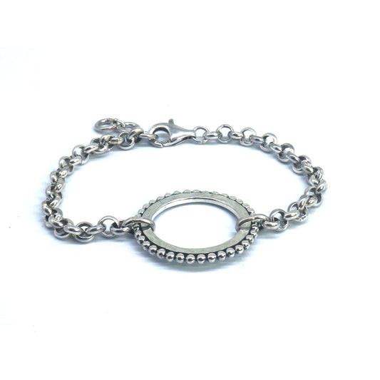 Silver bracelet with one center ring station.