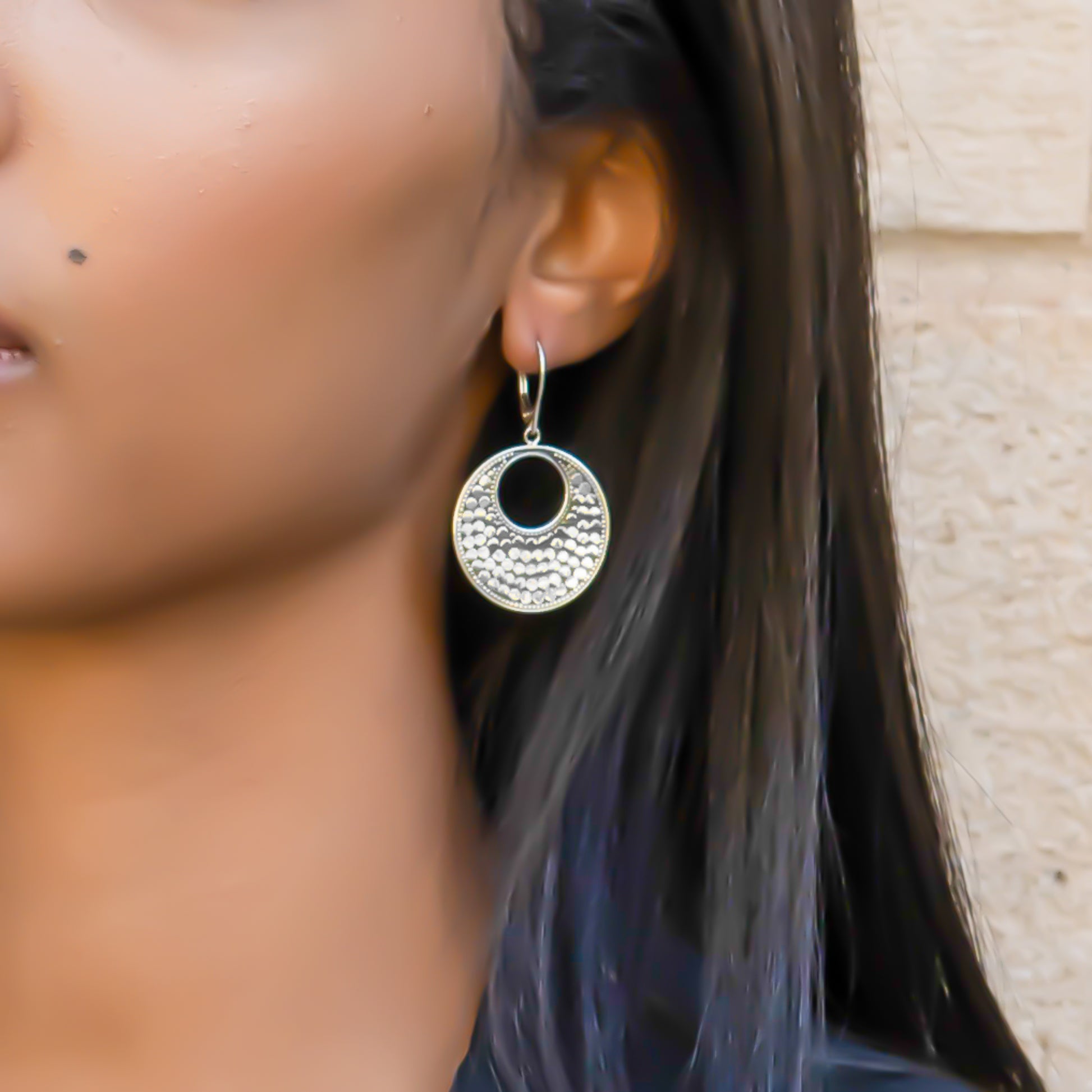 Sterling silver dotted disc earrings.
