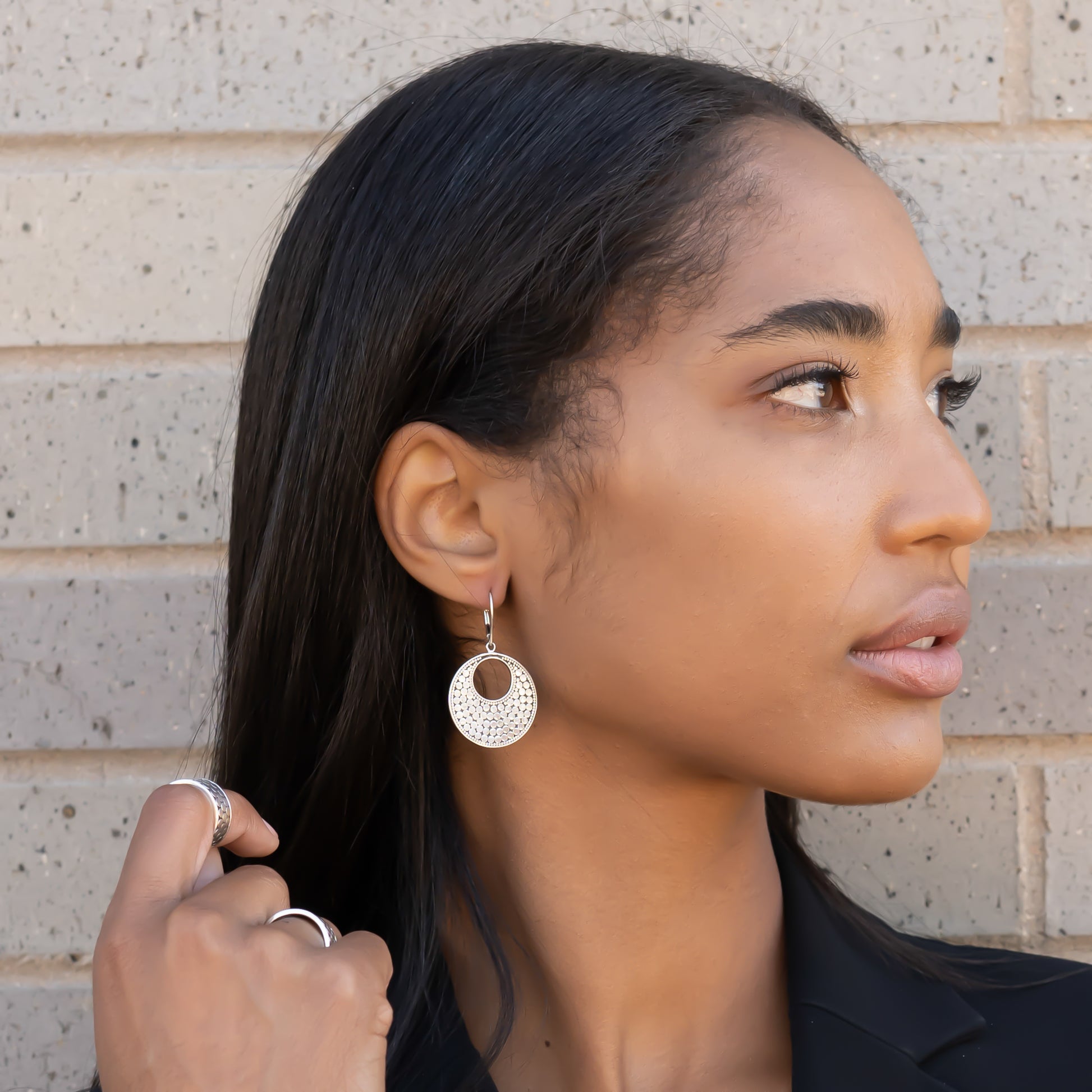 Sterling silver dotted disc earrings.