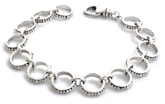 Silver link bracelet with beads around each link.